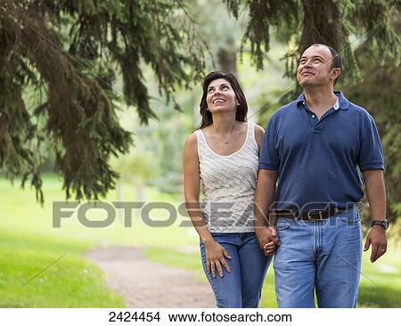 Married couple walking in a park spending quality time together; Edmonton, Alberta, Canada View Large Photo Image Picture - Married couple walking in a park spending quality time together; Edmonton, Alberta, Canada. Fotosearch