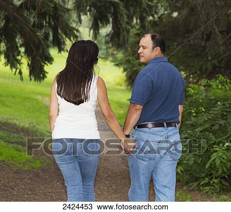 Married couple walking in a park spending quality time together; Edmonton, Alberta, Canada View Large Photo Image Stock Image - Married couple walking in a park spending quality time together; Edmonton, Alberta, Canada. Fotosearch
