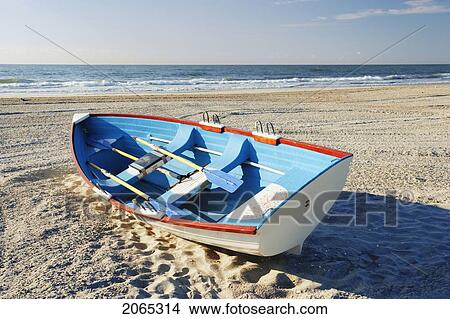 Mature Man Sitting On Beach And Small Boat, New Jersy, Usa. View Large Photo Image Picture - Mature Man Sitting On Beach And Small Boat, New Jersy, Usa.. Fotosearch