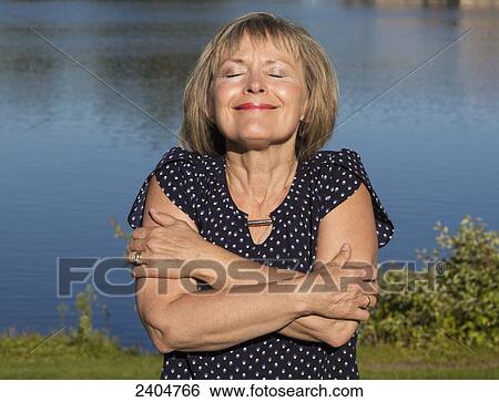 Mature woman relaxing in Hawrelak Park; Edmonton, Alberta, Canada View Large Photo Image Stock Photograph - Mature woman relaxing in Hawrelak Park; Edmonton, Alberta, Canada. Fotosearch