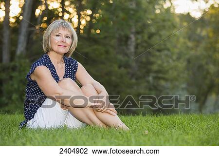 Mature woman sitting contentedly in a park; Edmonton, Alberta, Canada View Large Photo Image Stock Image - Mature woman sitting contentedly in a park; Edmonton, Alberta, Canada. Fotosearch