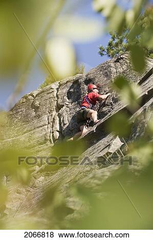 Mid-Age Man Climbing Up 5. 8 Route At Stone Hills Near Rexford, Montana, Usa View Large Photo Image Stock Photo - Mid-Age Man Climbing Up 5. 8 Route At Stone Hills Near Rexford, Montana, Usa. Fotosearch