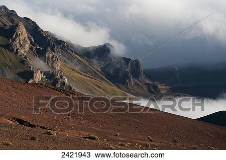 Morning clouds begin to burn off of Haleakala National Park; Maui, Hawaii, United States of America View Large Photo Image Stock Image - Morning clouds begin to burn off of Haleakala National Park; Maui, Hawaii, United States of America. Fotosearch