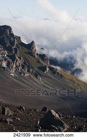 Stock Photo - Morning clouds begin to burn off of Haleakala National Park; Maui, Hawaii, United States of America. Fotosearch