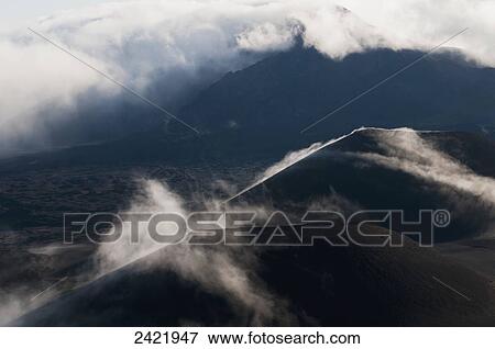 Stock Photo - Morning clouds begin to burn off of Haleakala National Park; Maui, Hawaii, United States of America. Fotosearch