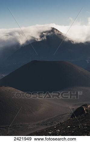 Morning clouds begin to burn off of Haleakala National Park; Maui, Hawaii, United States of America View Large Photo Image Stock Photo - Morning clouds begin to burn off of Haleakala National Park; Maui, Hawaii, United States of America. Fotosearch