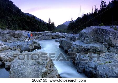 Mother And Daughter At Sunset Looking At Rushing River, Vancouver Island, Canada View Large Photo Image Stock Photography - Mother And Daughter At Sunset Looking At Rushing River, Vancouver Island, Canada. Fotosearch