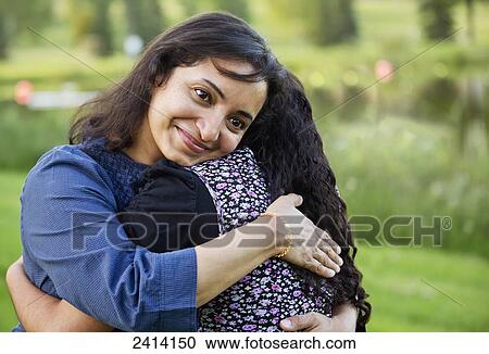 Mother and daughter in an embrace in a park; Edmonton, Alberta, Canada View Large Photo Image Stock Image - Mother and daughter in an embrace in a park; Edmonton, Alberta, Canada. Fotosearch