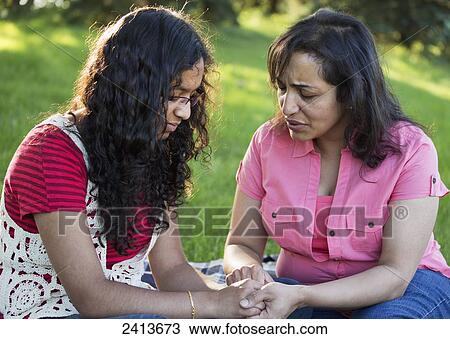 Mother and daughter praying together in a park; Edmonton, Alberta, Canada View Large Photo Image Stock Image - Mother and daughter praying together in a park; Edmonton, Alberta, Canada. Fotosearch