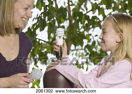 Mother And Daughter Replacing An Energy Efficient Light Bulb View Large Photo Image Stock Image - Mother And Daughter Replacing An Energy Efficient Light Bulb. Fotosearch