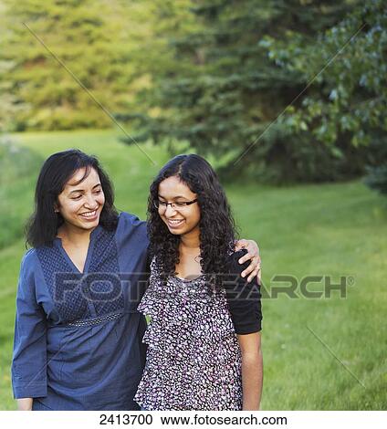Stock Image - Mother and daughter spending quality time together walking in a park; Edmonton, Alberta, Canada. Fotosearch