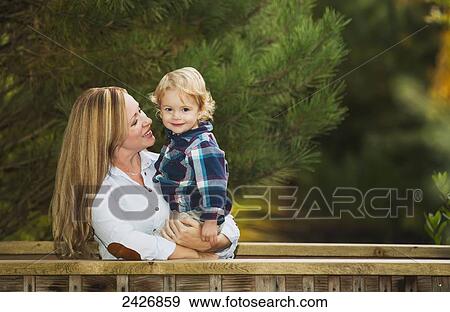 Mother and son outdoors in a park; Langley, British Columbia, Canada View Large Photo Image Stock Photo - Mother and son outdoors in a park; Langley, British Columbia, Canada. Fotosearch