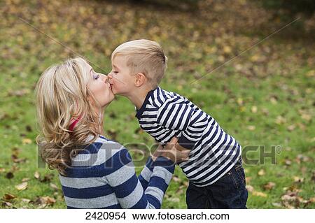 Mother and son sharing a tender moment in a park in autumn; Edmonton, Alberta, Canada View Large Photo Image Picture - Mother and son sharing a tender moment in a park in autumn; Edmonton, Alberta, Canada. Fotosearch