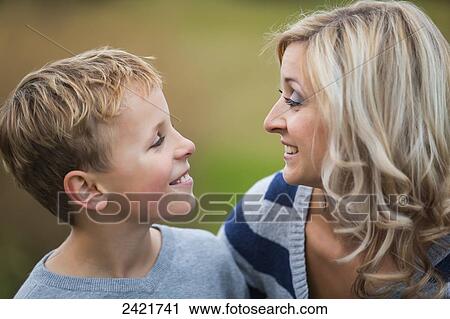 Mother and son talking in a park in autumn; Edmonton, Alberta, Canada View Large Photo Image Stock Image - Mother and son talking in a park in autumn; Edmonton, Alberta, Canada. Fotosearch