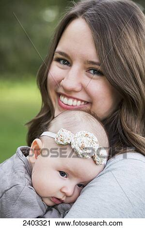 Mother with her infant daughter in a park; Edmonton, Alberta, Canada View Large Photo Image Stock Image - Mother with her infant daughter in a park; Edmonton, Alberta, Canada. Fotosearch