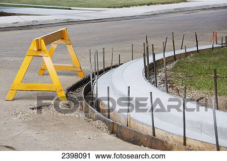Stock Image - New curb installation on roadway; Edmonton, Alberta, Canada. Fotosearch