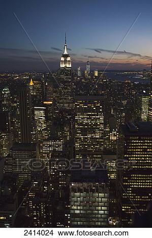 New York City buildings illuminated at nighttime; New York City, New York, United States of America View Large Photo Image Picture - New York City buildings illuminated at nighttime; New York City, New York, United States of America. Fotosearch