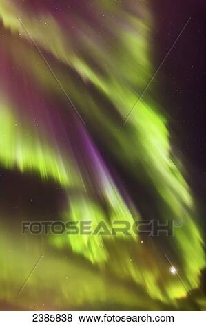 Stock Photo - Northern Lights and the moon in the sky above the Tony Knowles Coastal Trail, Anchorage Coastal Refuge; Anchorage, Alaska, United States of America. Fotosearch
