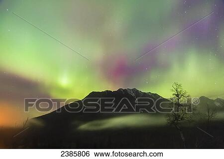 Northern Lights in the sky above Moose Pass, with silhouetted Kenai Mountains in the fog and low cloud, Chugach National Forest; Moose Pass, Alaska, United States of America View Large Photo Image Stock Photograph - Northern Lights in the sky above Moose Pass, with silhouetted Kenai Mountains in the fog and low cloud, Chugach National Forest; Moose Pass, Alaska, United States of America. Fotosearch