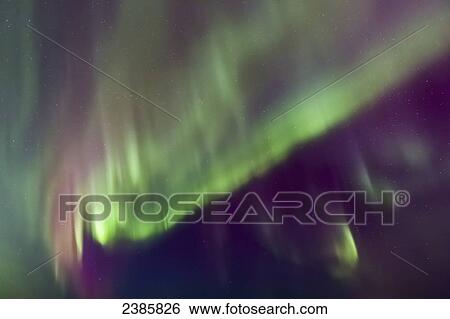 Stock Photograph - Northern Lights in the sky above the Tony Knowles Coastal Trail, Anchorage Coastal Refuge; Anchorage, Alaska, United States of America. Fotosearch