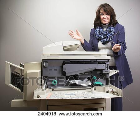 Office worker frustrated with paper jam in photocopier; Edmonton, Alberta, Canada View Large Photo Image Stock Photo - Office worker frustrated with paper jam in photocopier; Edmonton, Alberta, Canada. Fotosearch