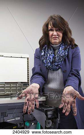 Stock Photo - Office worker trying to replace a toner cartridge in a photocopier; Edmonton, Alberta, Canada. Fotosearch