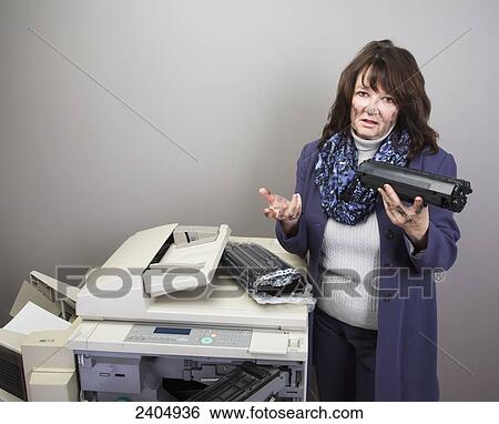 Stock Photograph - Office worker trying to replace a toner cartridge in a photocopier; Edmonton, Alberta, Canada. Fotosearch