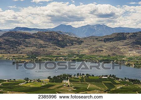 Stock Photograph - Okanagan lake, vineyards and mountains; Penticton, British Columbia, Canada. Fotosearch