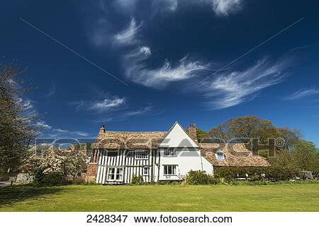 Old timber framed cottage on the village green of Great Wilbraham; Cambridgeshire, England View Large Photo Image Stock Photo - Old timber framed cottage on the village green of Great Wilbraham; Cambridgeshire, England. Fotosearch