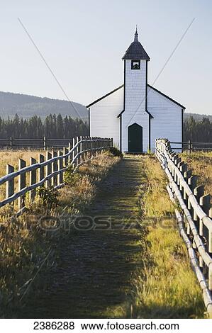 Old wooden church in foothills with wooden fence and blue sky; Cochrane, Alberta, Canada View Large Photo Image Stock Photo - Old wooden church in foothills with wooden fence and blue sky; Cochrane, Alberta, Canada. Fotosearch