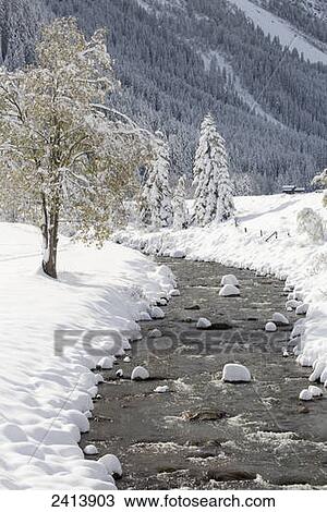 Open creek along snow covered banks with snow covered trees and mountain slope in the background; Hintertux, Austria View Large Photo Image Stock Image - Open creek along snow covered banks with snow covered trees and mountain slope in the background; Hintertux, Austria. Fotosearch