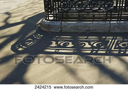 Ornate railing and it's shadow cast on the concrete pathway; Paris, France View Large Photo Image Stock Photography - Ornate railing and it's shadow cast on the concrete pathway; Paris, France. Fotosearch