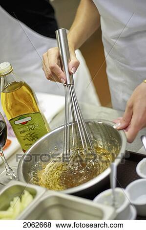 Person Whisking Bowl Of Olive Oil With Herbs And Spices View Large Photo Image Stock Photo - Person Whisking Bowl Of Olive Oil With Herbs And Spices. Fotosearch