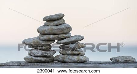 Pile of stones built on a wooden surface with Lake Winnipeg in the background at sunset; Riverton, Manitoba, Canada View Large Photo Image Stock Image - Pile of stones built on a wooden surface with Lake Winnipeg in the background at sunset; Riverton, Manitoba, Canada. Fotosearch
