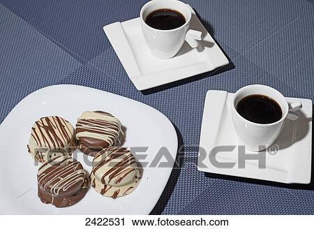 Plate of cookies and two cups of coffee on a blue background; Mendoza, Argentina View Large Photo Image Stock Image - Plate of cookies and two cups of coffee on a blue background; Mendoza, Argentina. Fotosearch