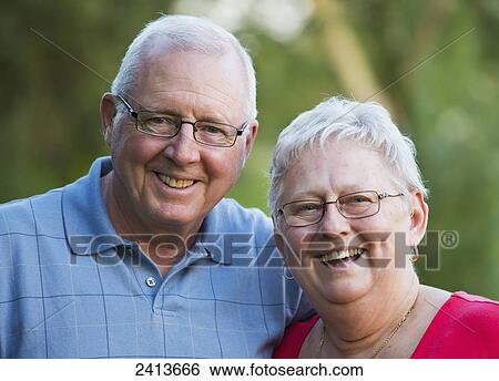Stock Photograph - Portait of a senior couple outdoors; Edmonton, Alberta, Canada. Fotosearch