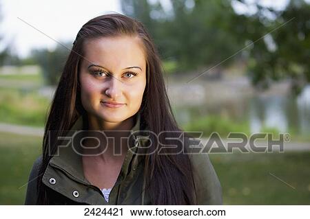 Portrait of a beautiful young woman in a park at twilight; St. Albert, Alberta, Canada View Large Photo Image Stock Image - Portrait of a beautiful young woman in a park at twilight; St. Albert, Alberta, Canada. Fotosearch