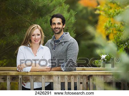 Portrait of a couple on a bridge in a park; Langley, British Columbia, Canada View Large Photo Image Stock Image - Portrait of a couple on a bridge in a park; Langley, British Columbia, Canada. Fotosearch