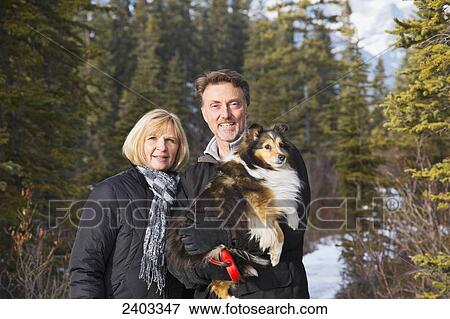 Portrait of a couple with their dog, near Canmore; Alberta, Canada View Large Photo Image Stock Photo - Portrait of a couple with their dog, near Canmore; Alberta, Canada. Fotosearch