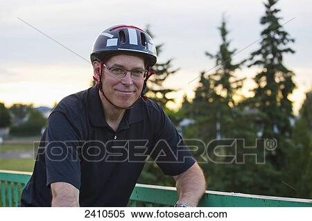 Portrait of a cyclist on a bridge; Edmonton, Alberta, Canada View Large Photo Image Stock Photography - Portrait of a cyclist on a bridge; Edmonton, Alberta, Canada. Fotosearch