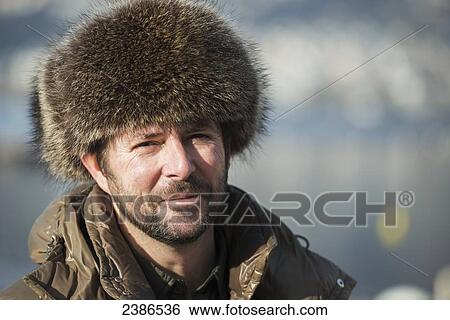 Portrait of a man wearing a fur hat; Locarno, Ticino, Switzerland View Large Photo Image Stock Photograph - Portrait of a man wearing a fur hat; Locarno, Ticino, Switzerland. Fotosearch