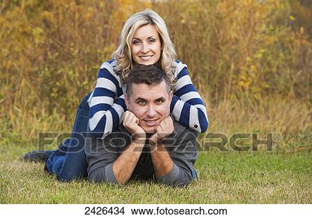 Picture - Portrait of a married couple in a park in autumn; Edmonton, Alberta, Canada. Fotosearch