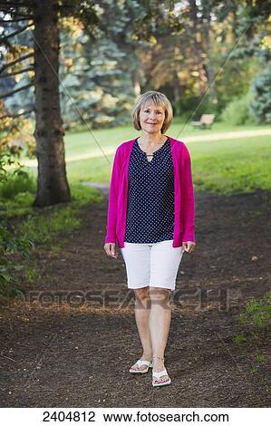 Portrait of a mature woman walking in Hawrelak park; Edmonton, Alberta, Canada View Large Photo Image Stock Image - Portrait of a mature woman walking in Hawrelak park; Edmonton, Alberta, Canada. Fotosearch