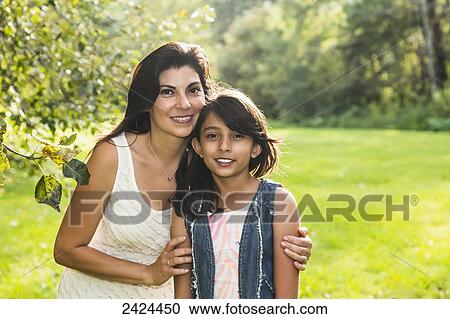 Stock Image - Portrait of a mother and daughter in a park; Edmonton, Alberta, Canada. Fotosearch