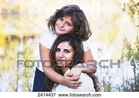 Stock Photo - Portrait of a mother and daughter in a park, in autumn; Edmonton, Alberta, Canada. Fotosearch