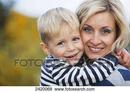 Portrait of a mother and young son in a park in autumn; Edmonton, Alberta, Canada View Large Photo Image Stock Photo - Portrait of a mother and young son in a park in autumn; Edmonton, Alberta, Canada. Fotosearch