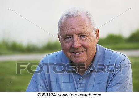 Portrait of a senior man in a park; Edmonton, Alberta, Canada View Large Photo Image Picture - Portrait of a senior man in a park; Edmonton, Alberta, Canada. Fotosearch