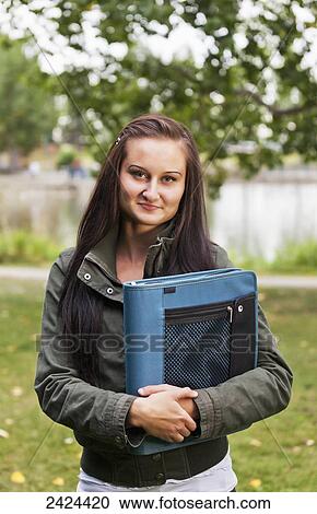 Portrait of a student in a park; St. Albert, Alberta, Canada View Large Photo Image Stock Image - Portrait of a student in a park; St. Albert, Alberta, Canada. Fotosearch