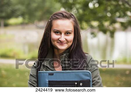 Portrait of a student in a park; St. Albert, Alberta, Canada View Large Photo Image Stock Photo - Portrait of a student in a park; St. Albert, Alberta, Canada. Fotosearch