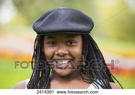 Stock Image - Portrait of a teenage girl in a park; Edmonton, Alberta, Canada. Fotosearch